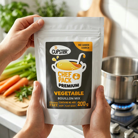 Hands holding a Chef-Pack Premium vegetable bouillon mix pouch in a kitchen